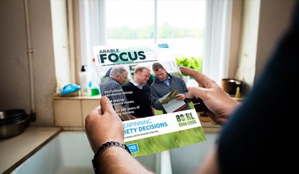 A person holding a magazine (Arable Focus Summer 2024)